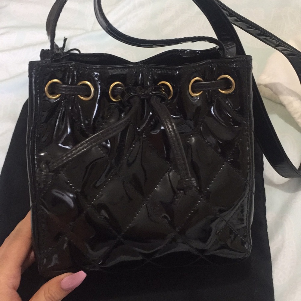 Chanel handbag with Gold logo on handle.